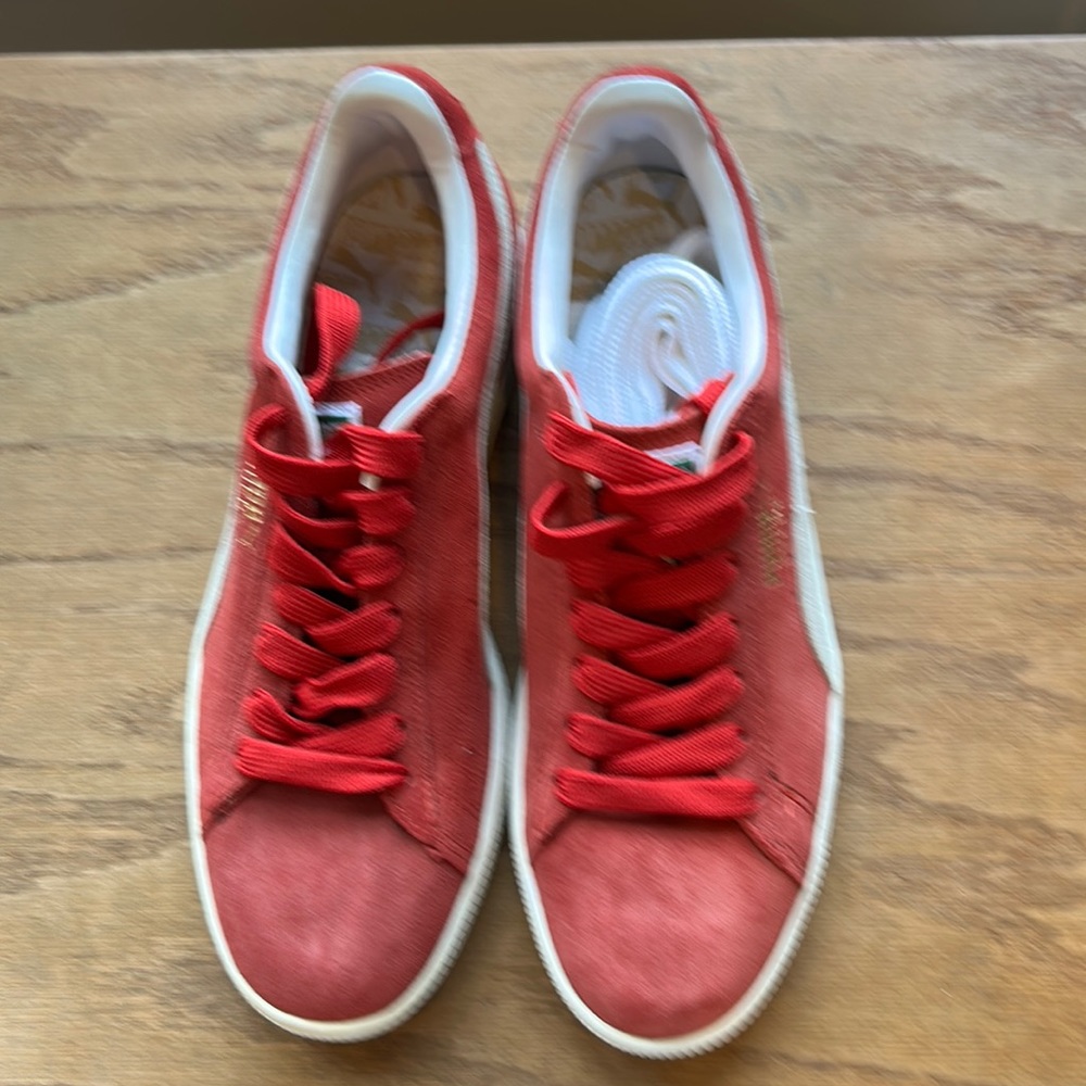 Brand new red Puma sneakers, never worn.